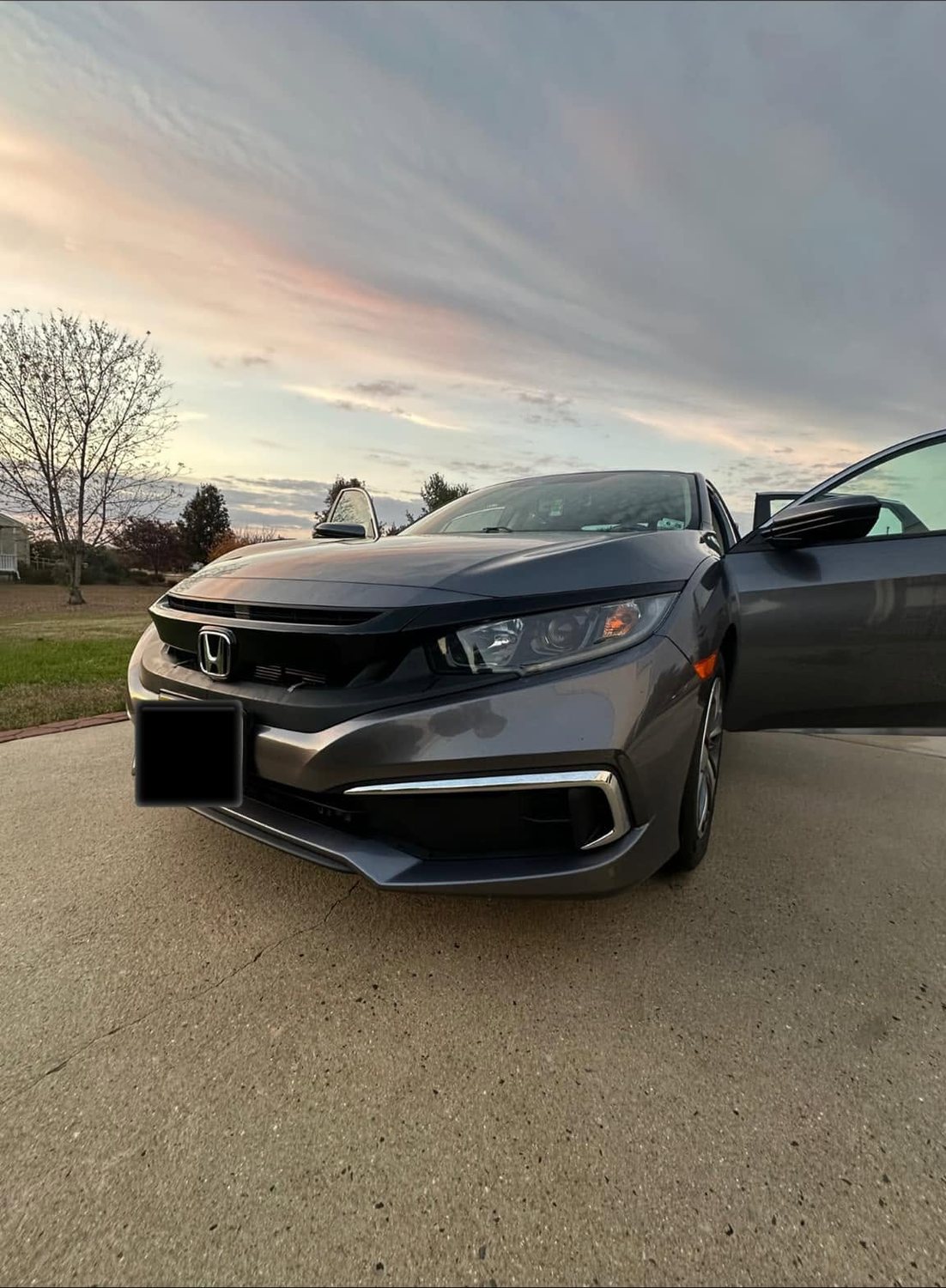 Grey Honda Civic gleaming at sunset after a full exterior detail